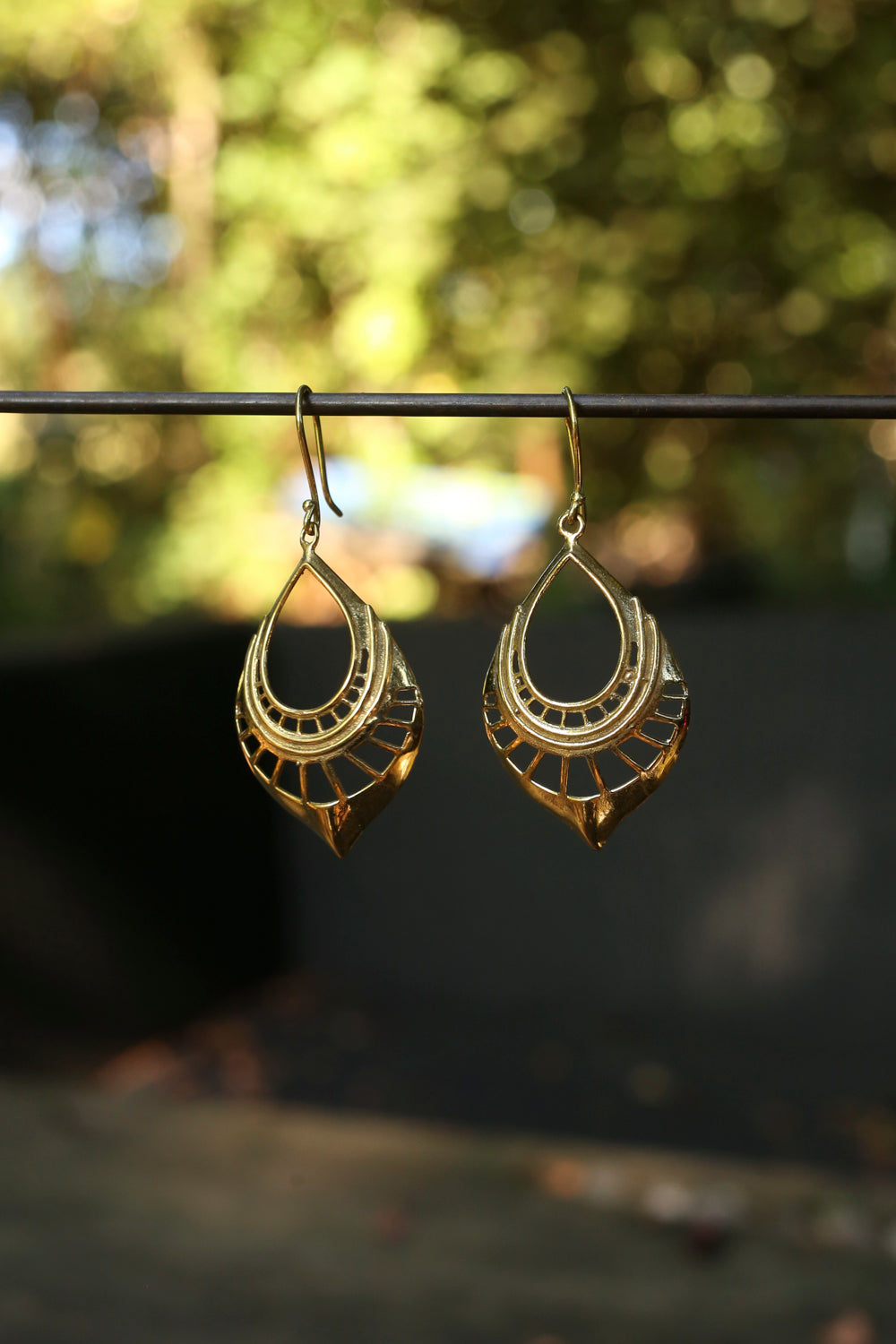 brass hoop earrings on a blurred natural background