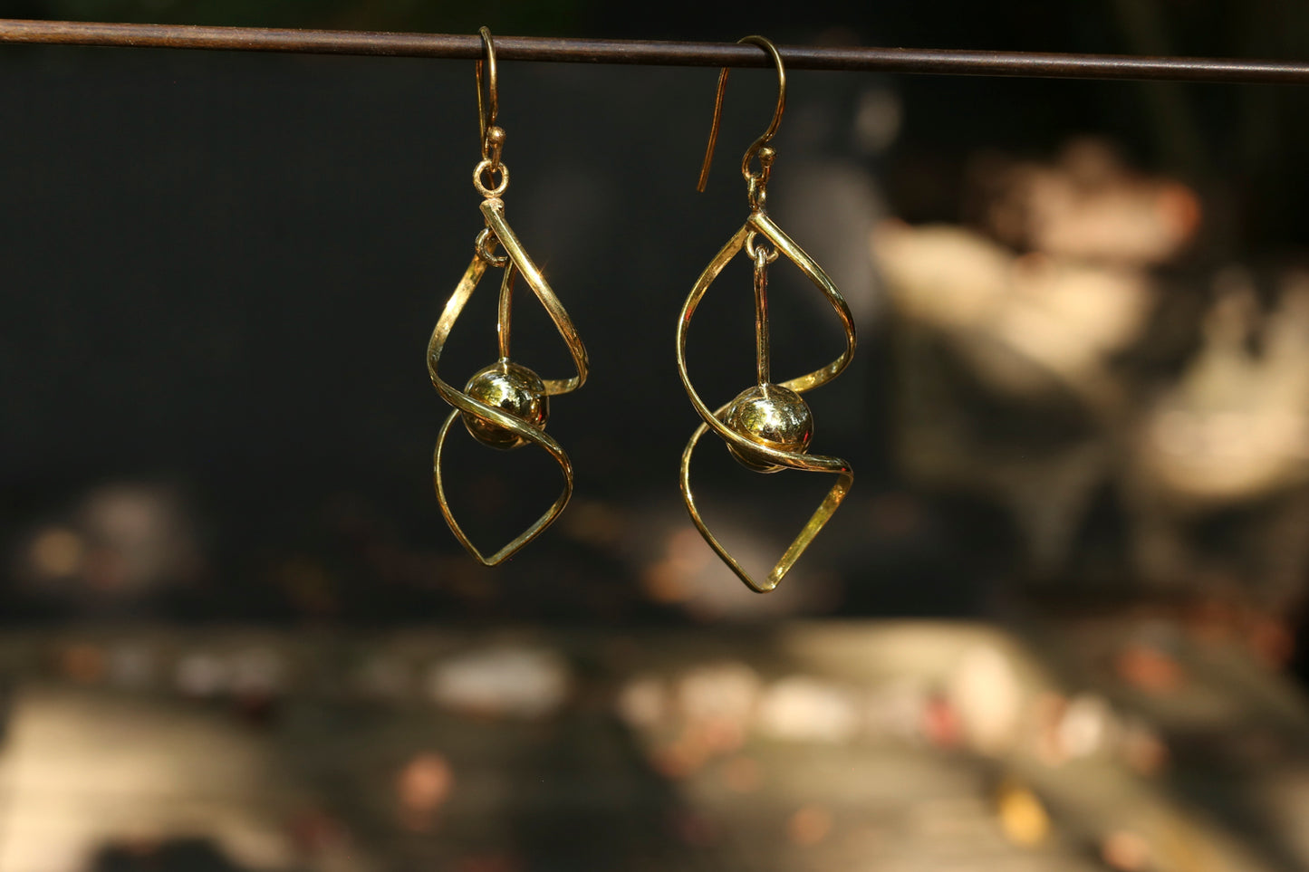 brass earrings with a blurred background