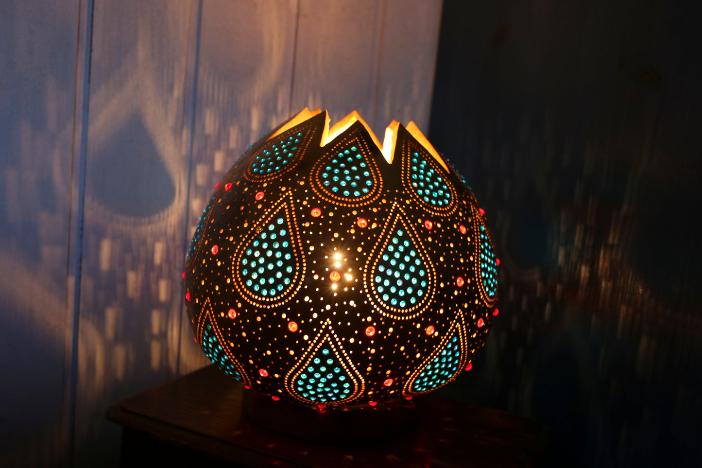Decorative lamp with intricate patterns on a dark background
