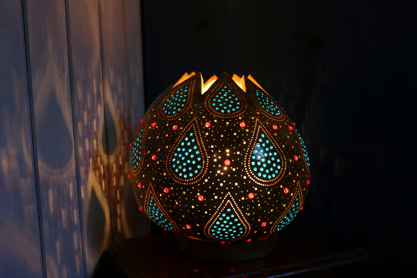 Decorative lamp with intricate patterns on a dark background
