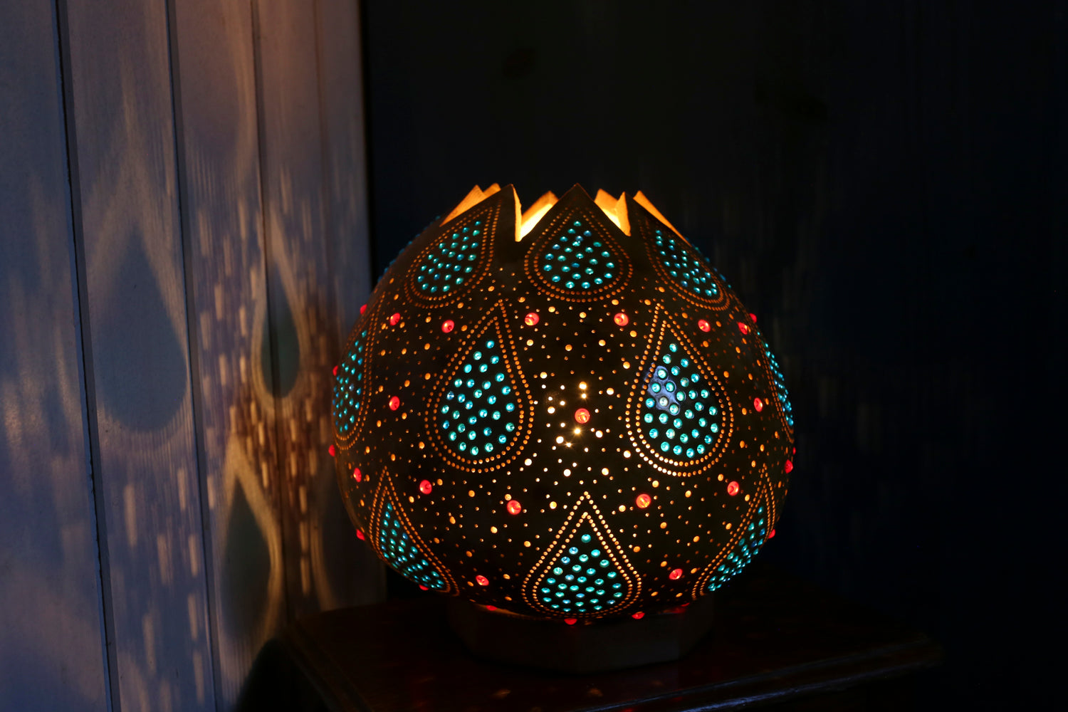 Decorative lamp with intricate patterns on a dark background