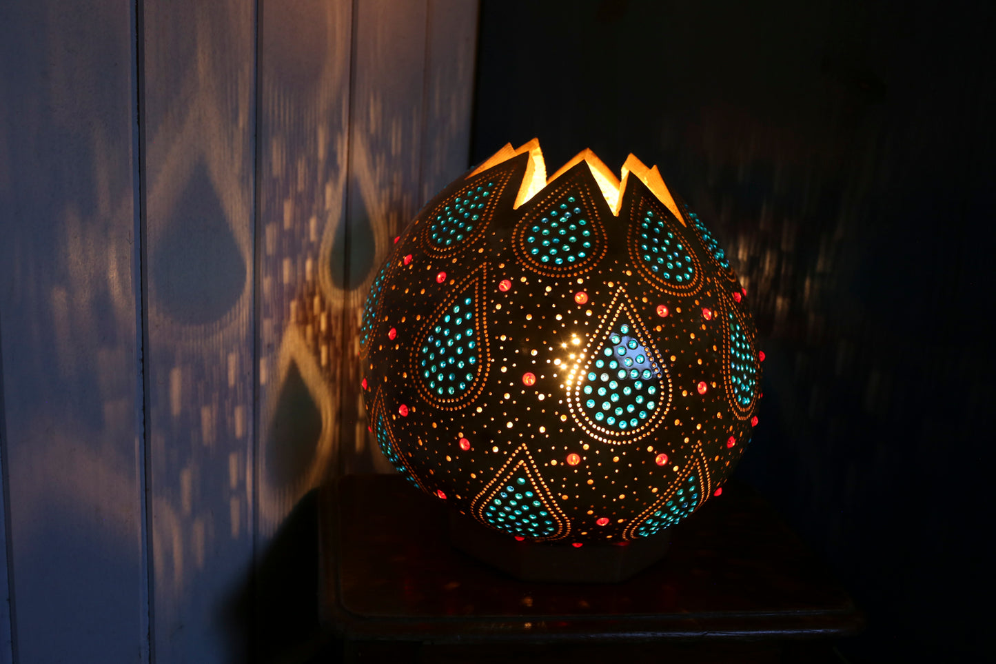 Decorative lamp with intricate patterns on a dark background