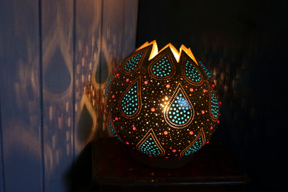 Decorative lamp with intricate patterns on a dark background