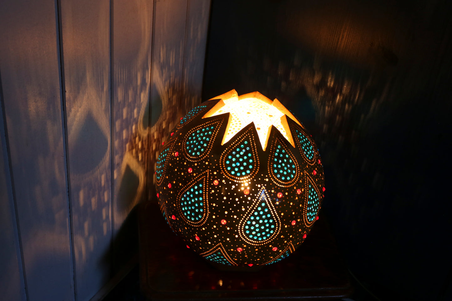 Decorative lamp with intricate patterns on a dark background