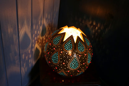 Decorative lamp with intricate patterns on a dark background