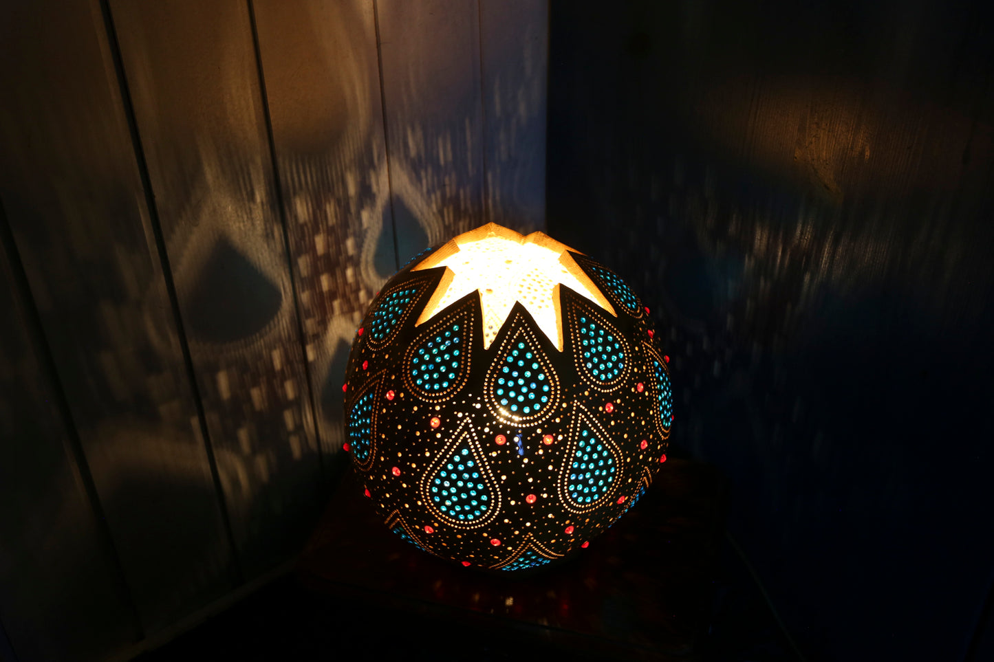 Decorative lamp with intricate patterns on a dark background