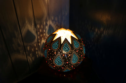 Decorative lamp with intricate patterns on a dark background