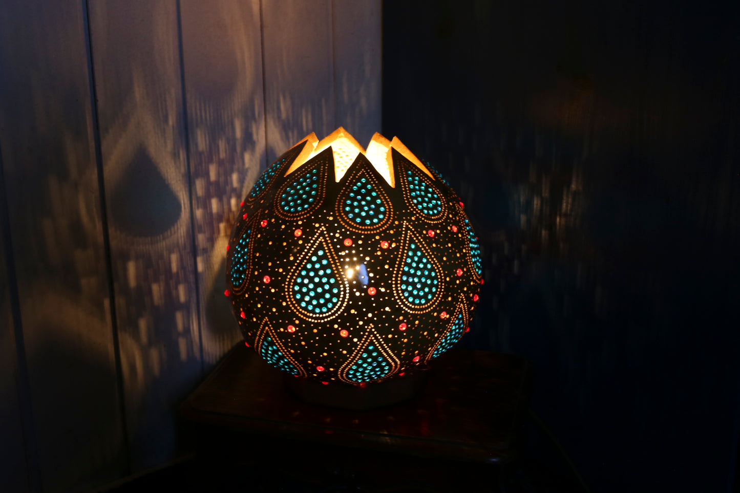 Decorative lamp with intricate patterns on a dark background