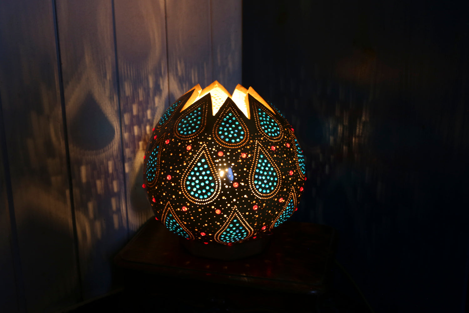 Decorative lamp with intricate patterns on a dark background