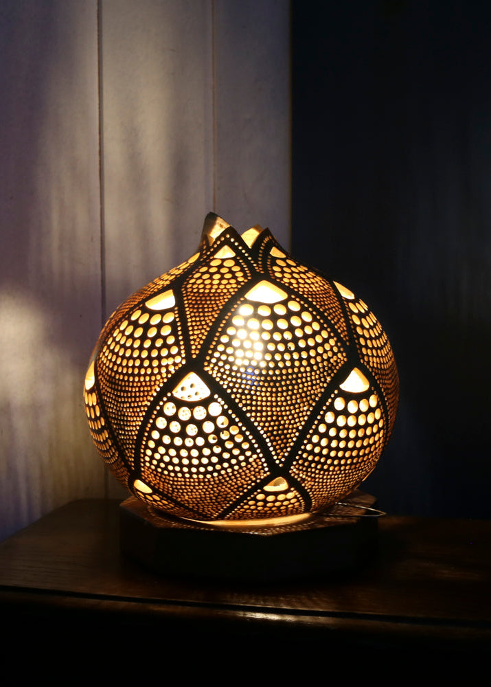Decorative lamp with intricate patterns on a dark background