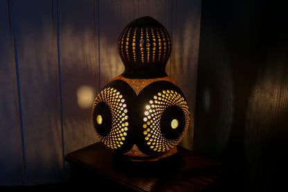 Decorative lamp with intricate patterns on a dark background