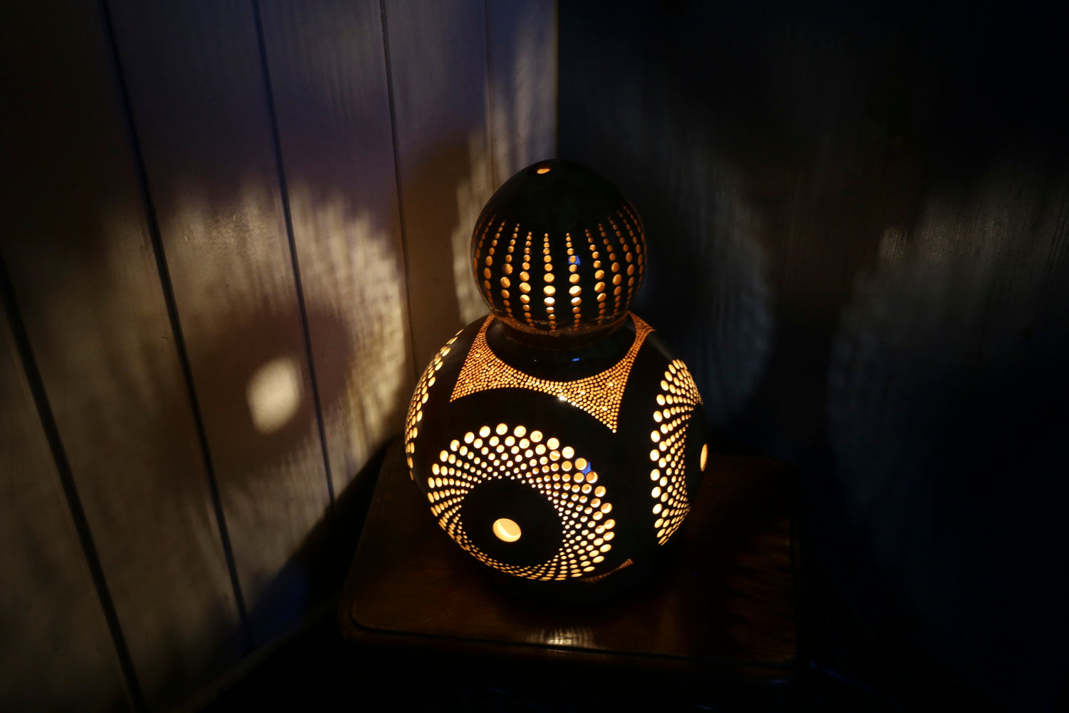 Decorative lamp with intricate patterns on a wooden surface
