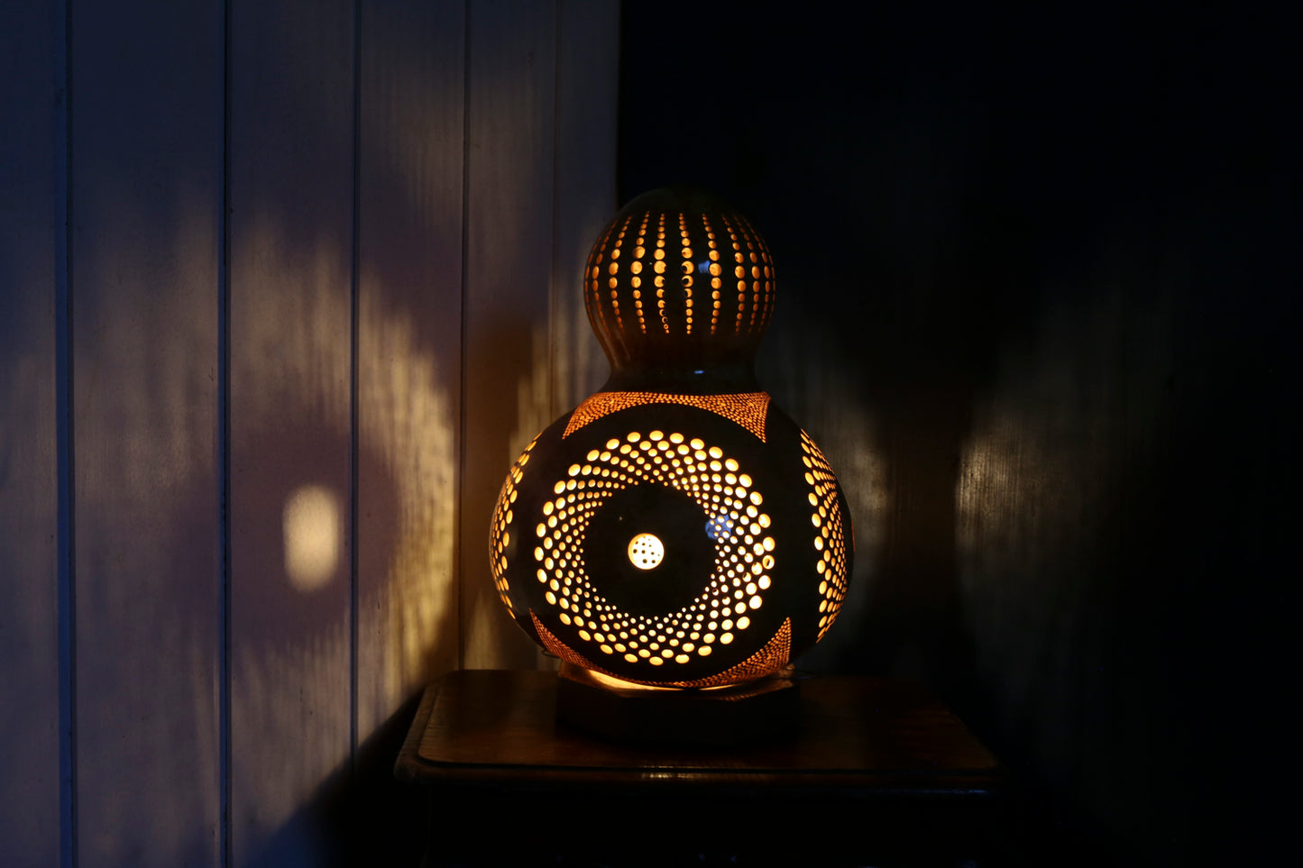 Decorative lamp with intricate design on a dark background