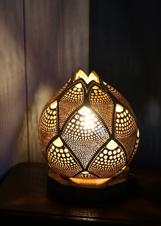 Decorative lamp with intricate patterns on a dark background