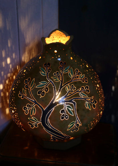 Decorative lamp with tree design on a dark background