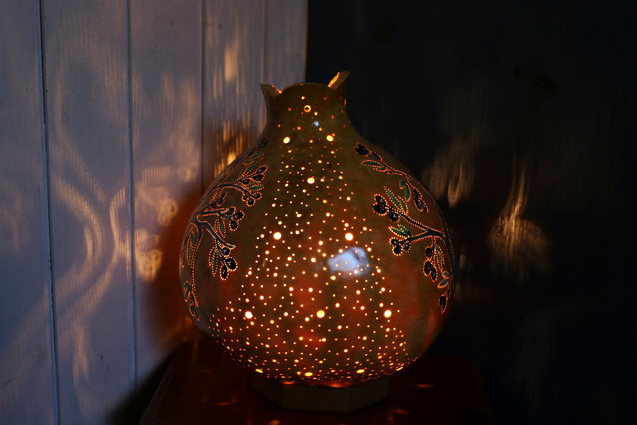 Decorative lamp with intricate patterns on a dark background