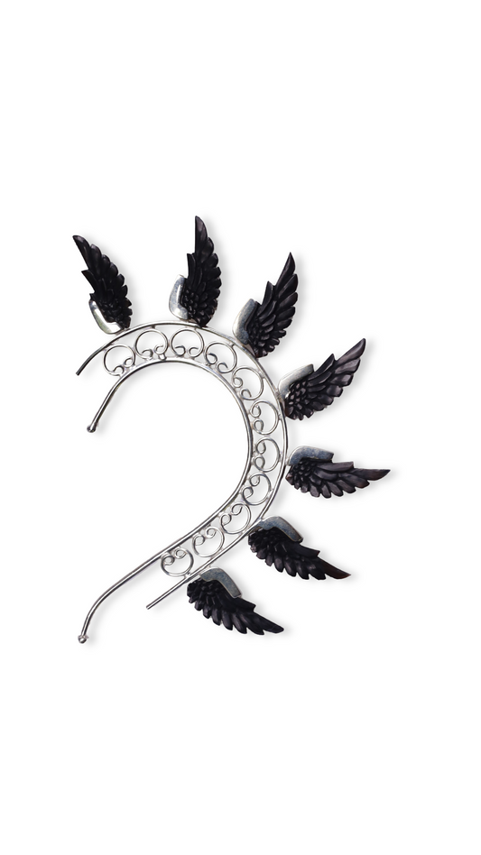 Decorative headband with black feather-like attachments on a white background

