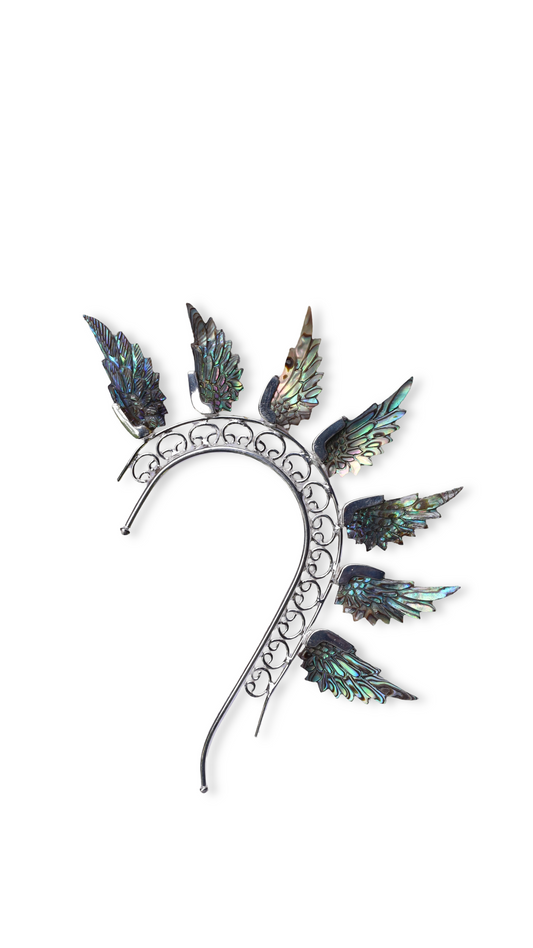 Decorative headpiece with feather-like elements on a white background