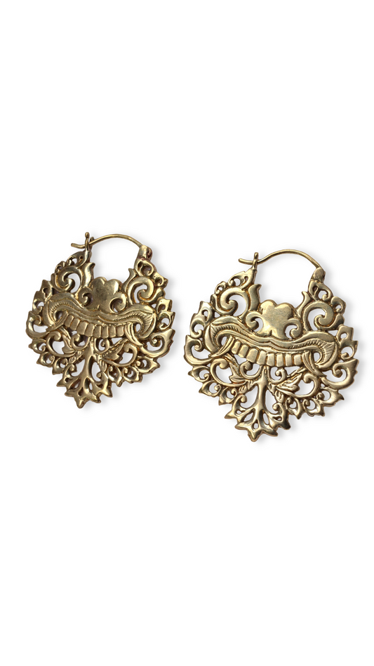 Pair of gold hoop earrings with intricate designs on a white background