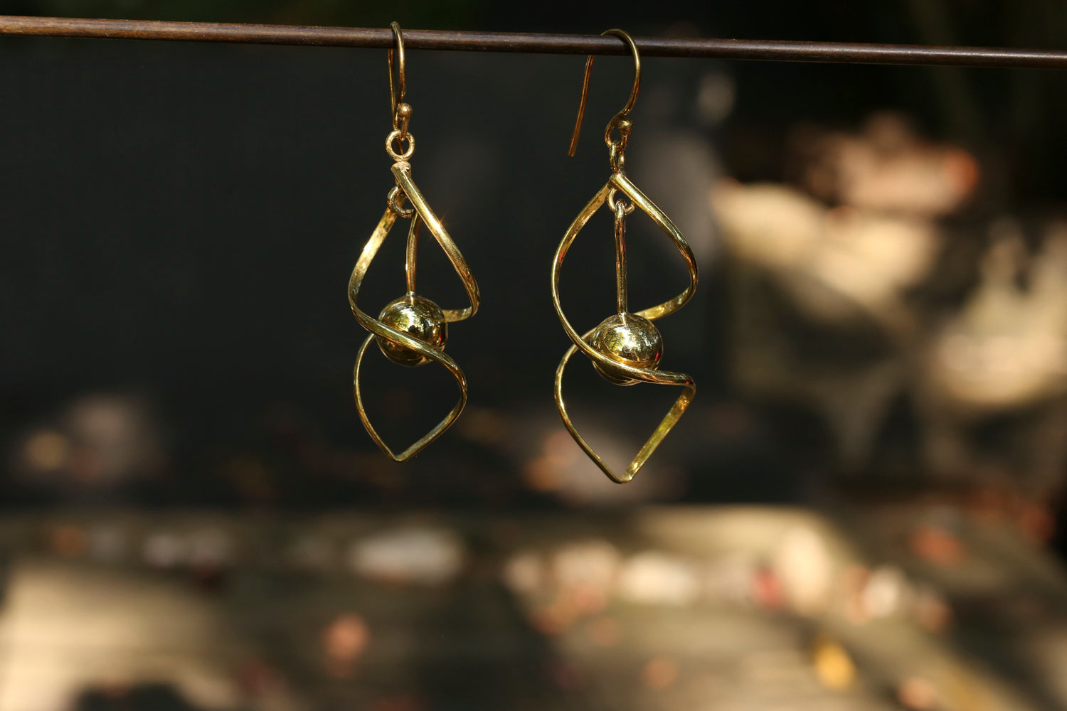 brass earrings with a blurred background