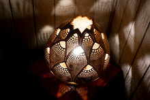 Load image into Gallery viewer, Image of a handcrafted calabash lamp. The gourd&#39;s surface is intricately carved with patterns that allow soft light to shine through, creating a warm and inviting ambiance. The lamp is a blend of natural elegance and artistry, casting gentle shadows that enhance its beauty